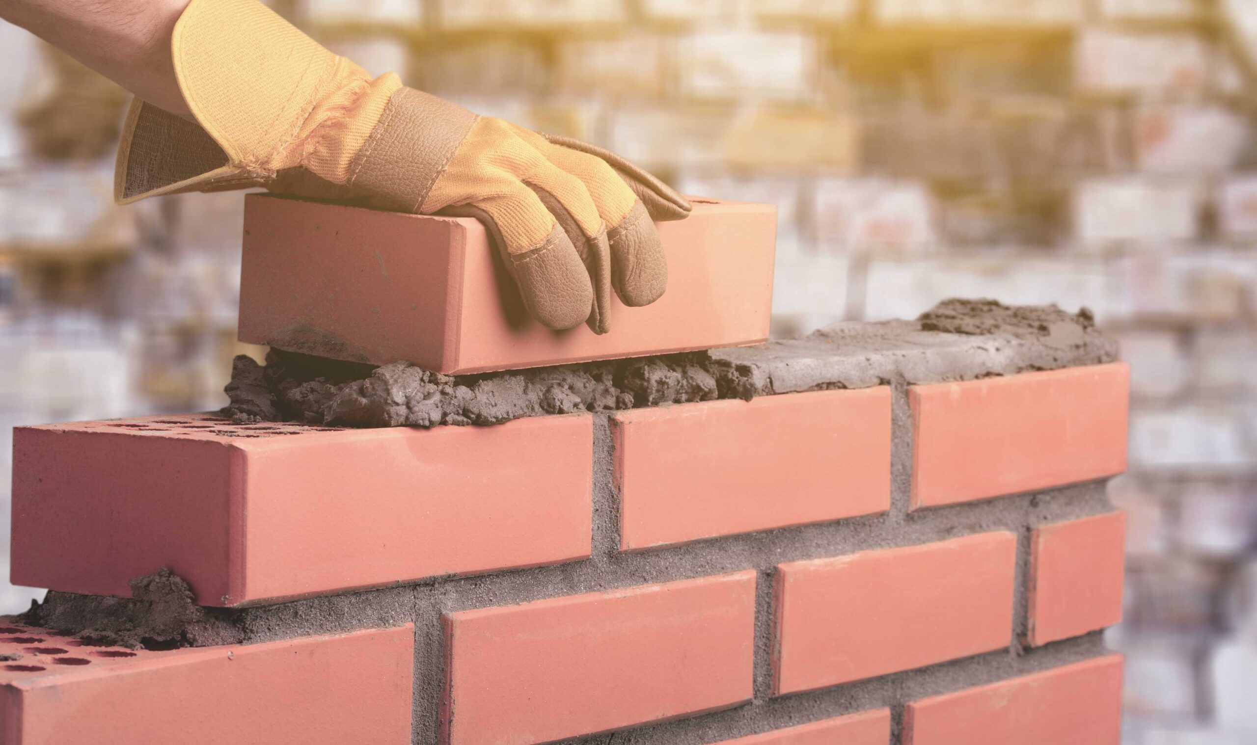 Worker builds a brick wall in the house